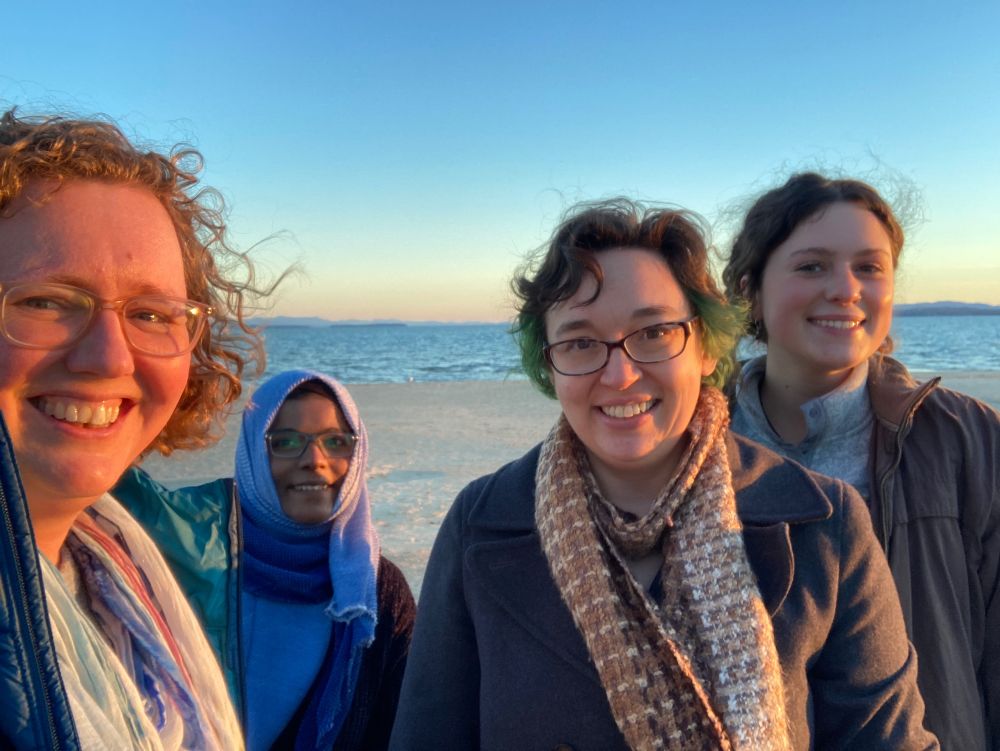 4 women in costa smile on a beach 