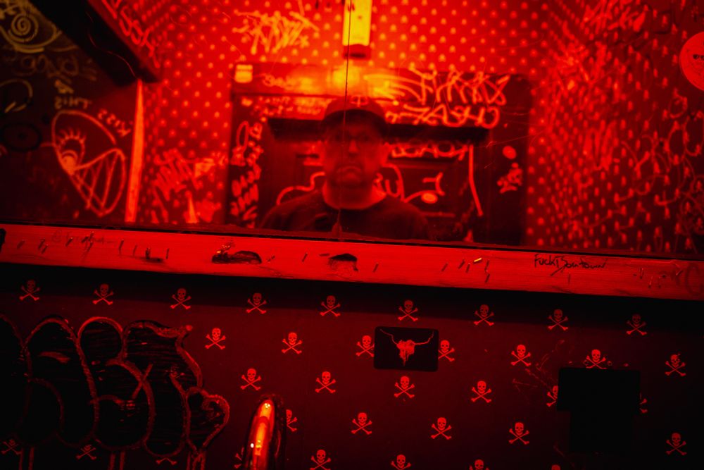 Mirrored self-portrait in a reddish tone. 