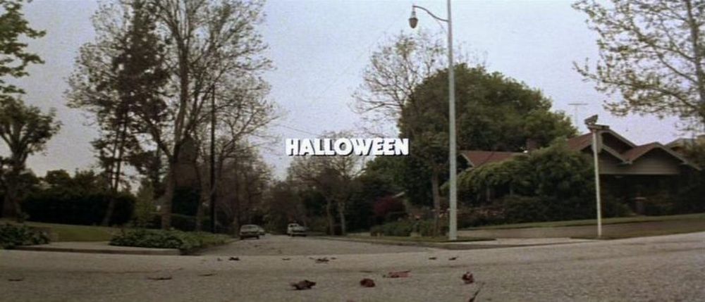 Empty road in Haddonfield, IL displaying the word “Halloween” in white letters; a frame from John Carpenter’s HALLOWEEN (1978).