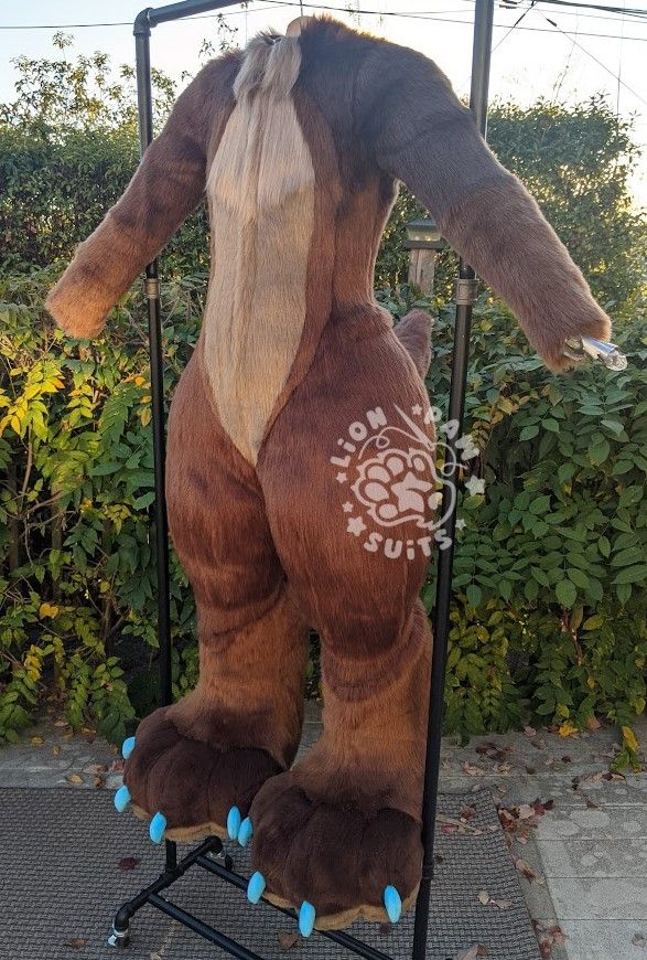 A canine fursuit displayed on a DTD in various browns and blue claws seen from the front quarter.