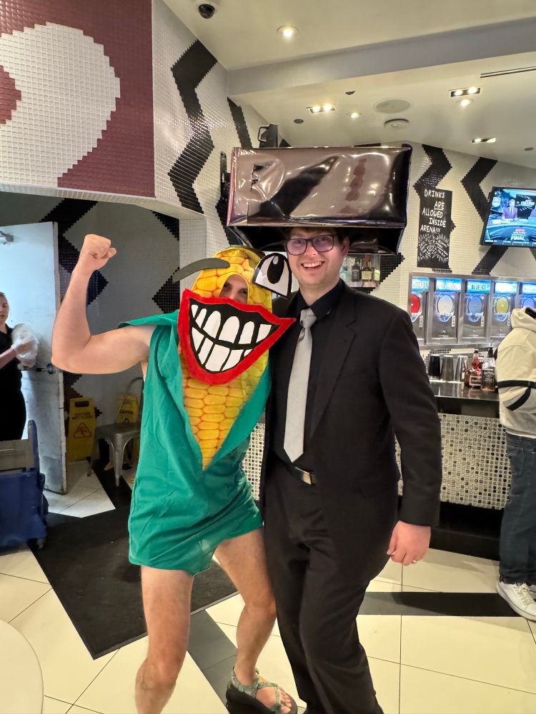 Me in my corn costume and John next to me with a large metallic hat