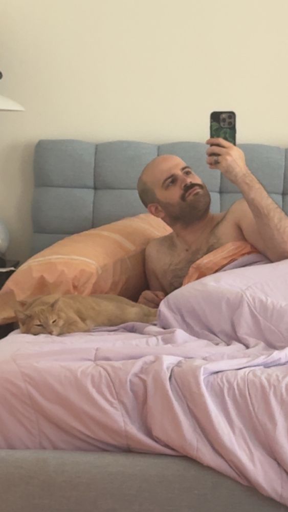 Me in bed, misty my cat lying next to me