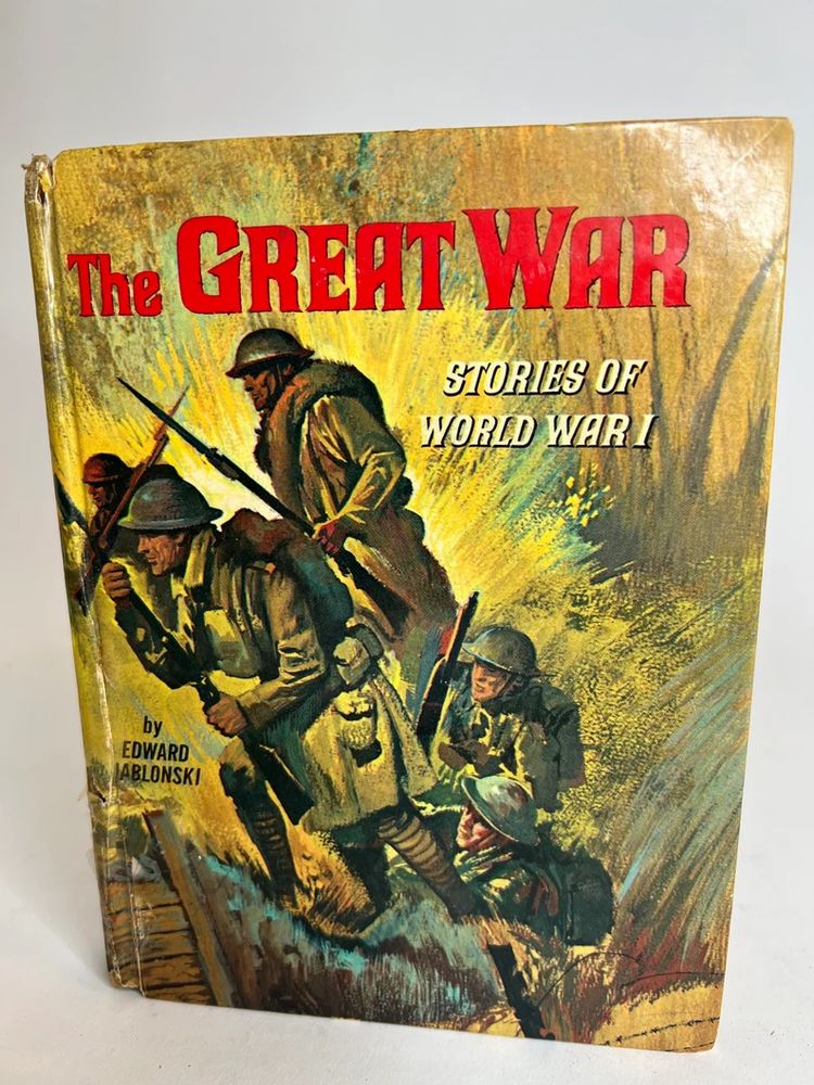 A vintage book cover in olive and yellow tones. Four soldiers are climbing out of a trench, with an explosion behind them. Title in red is: The Great War, Subtitle in white is Stories of World War 1.