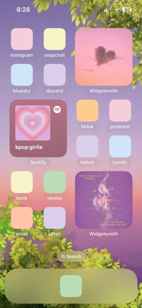my iphone homescreen, with a sunset photo background and pastel colored app icons