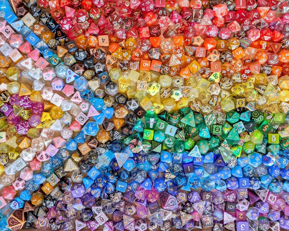 A pride flag made from a pile of rpg dice