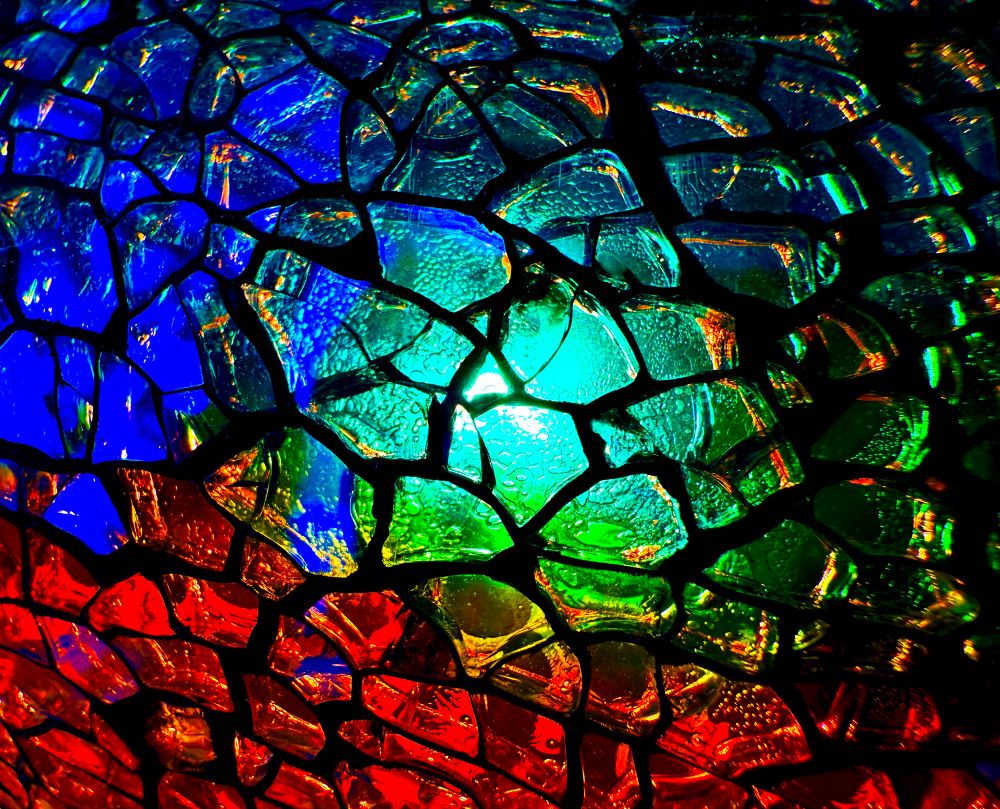 A blue, red and green crackled glass lit up from within