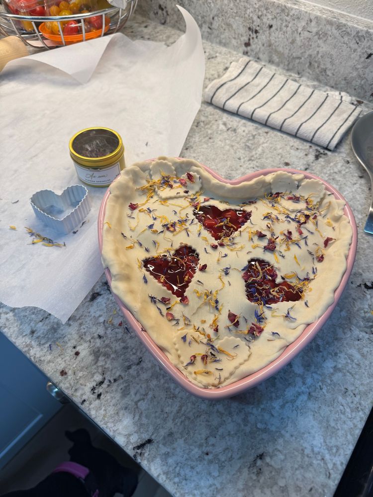 Cherry pie in a heart shaped pan ready to go into oven.