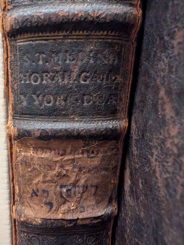 Old binding with English and Hebrew words