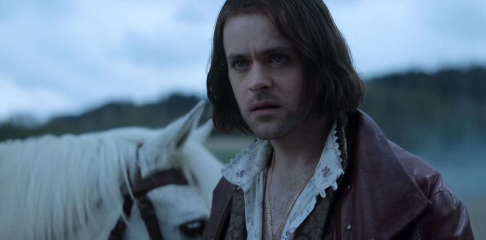 a screenshot of jaskier from the witcher netflix season 4 episode 1. he’s looking even more intensely after geralt, who just rode off on his horse while unsheathing his sword to heroically save some helpless civilian