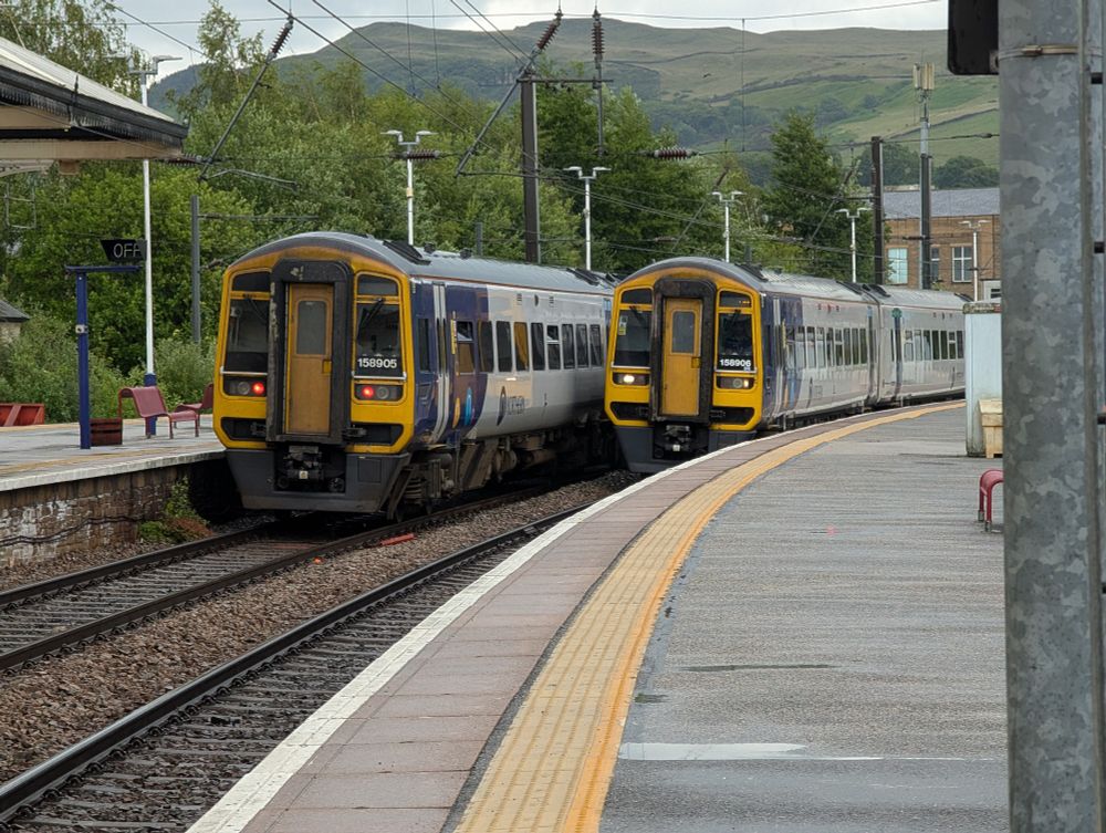 Trains 158905 and 158906 pass at Skipton station.