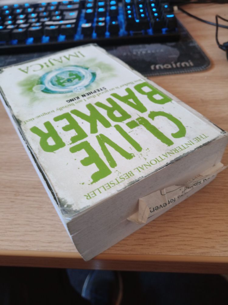 Clive Barker's book Imajica, with a receipt as bookmark