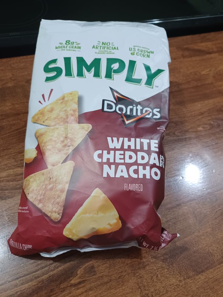 A bag of Simply Doritos White Cheddar Nacho flavored tortilla chips.