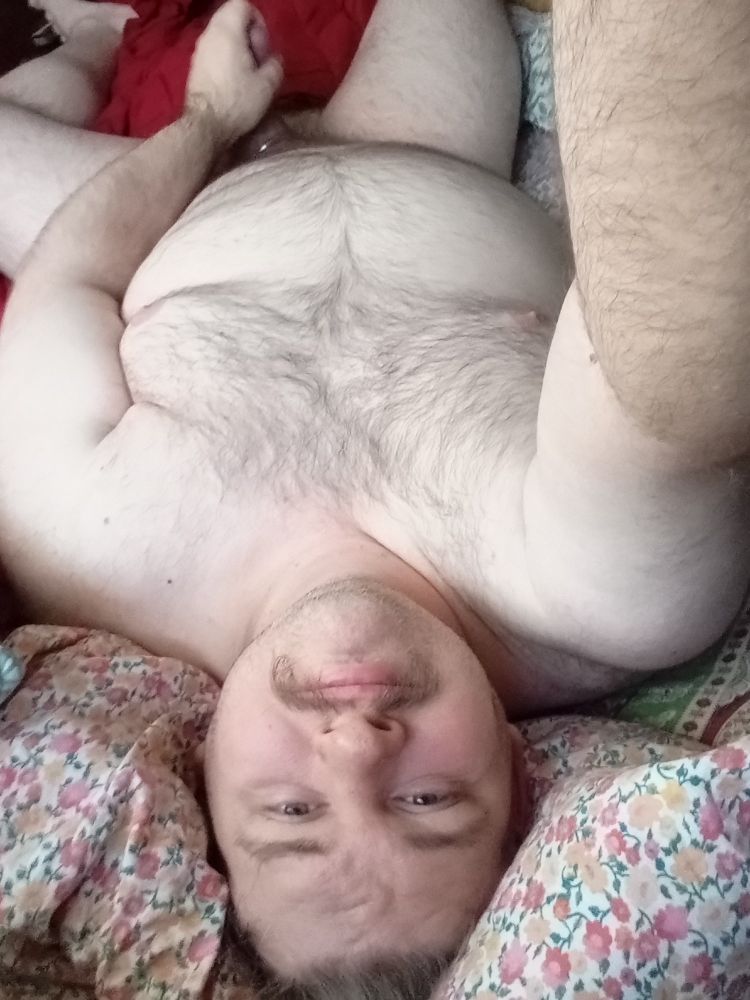 Naked bearish man strokes his cock in bed