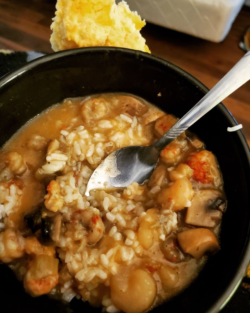 I don't want to call it Gumbo, but it's close enough. LOL (Picture is a bowl of rice with a dark brown broth, crawfish, mushrooms, shrimp and onion blend)
