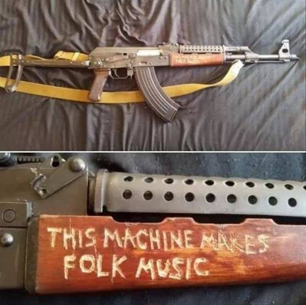 An automatic Rifle with “This Machine Makes Folk Music” carved into the forestock