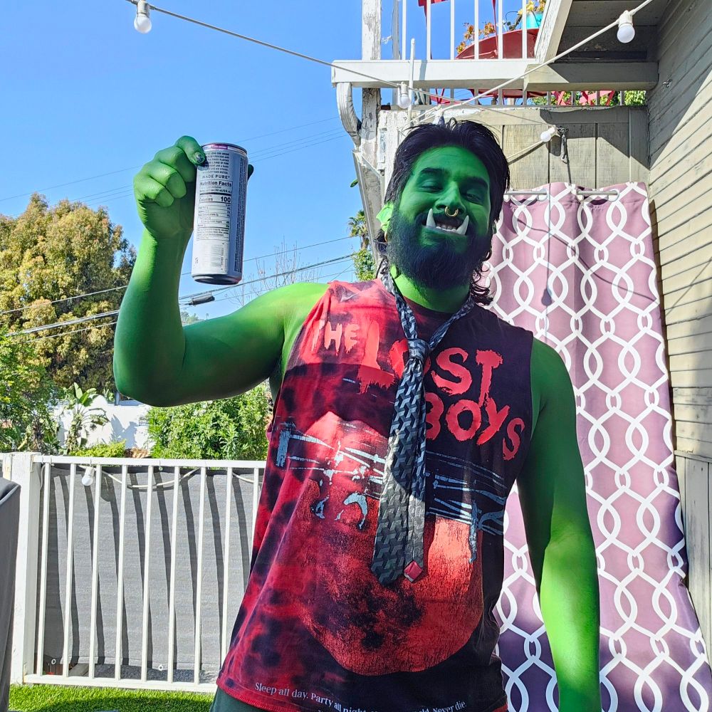 Orc holding booze in his right hand, smiling