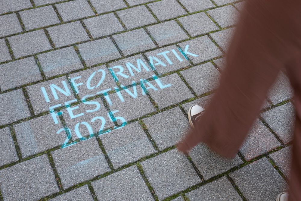 INFORMATIK FESTIVAL 2025 mit blauer Kreide auf den Boden gesprayt