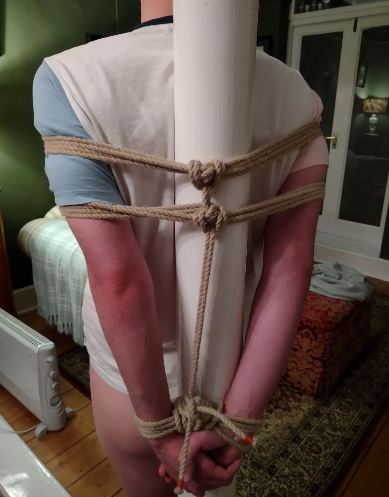 sunburned person tied up with rope