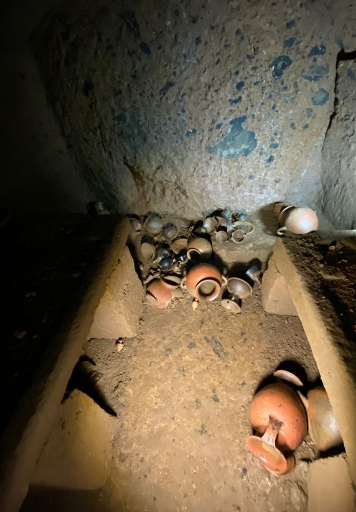 A view into the tomb, showing various pottery vessels