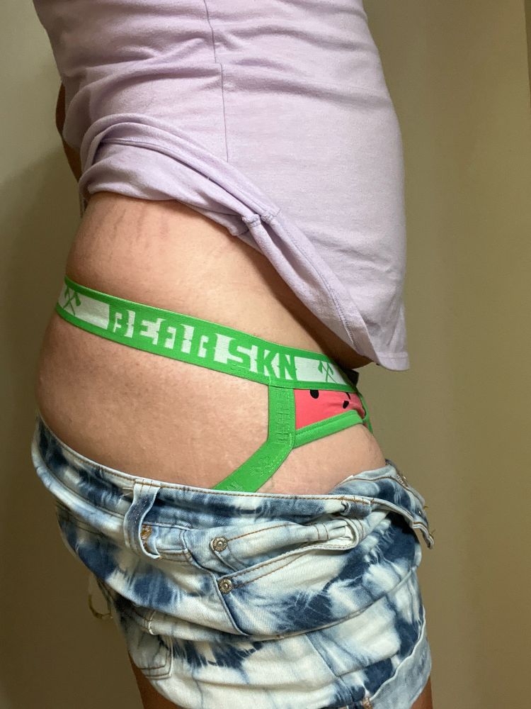 Me facing the side with my shorts pulled down slightly, revealing my jockstrap gripping at my ass