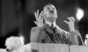 famous photo of adolph Hitler giving a speech and posing in similar fashion/camera angle to the Time magazine photo of Trump on its current cover.
