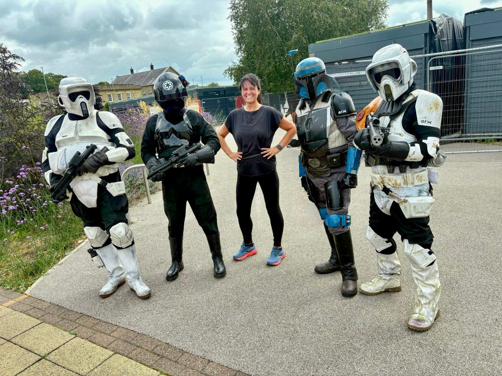 I am in the middle of a Star Wars line up, fresh from a 14K run. I am peak sweaty chic, standing proudly next to a squad of Star Wars characters in full Imperial armour. They look ready for battle and maybe mildly confused by my cardio. I am clearly the most excited, because nothing says 'cool adult' like fangirling in running gear next to Stormtroopers in Rawtenstall. 🙈
