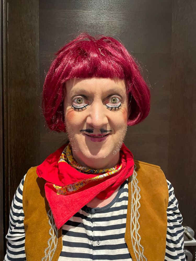 Man with a weird outfit, makeup and wig. The man was me, reader.