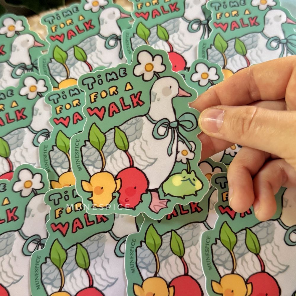 A sticker with a goose and pikmin characters and a frog that says “time for a walk”