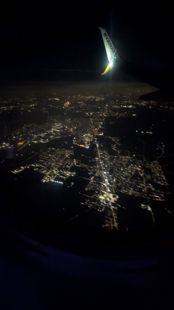 Slightly blurry picture of Milan from the sky at night 