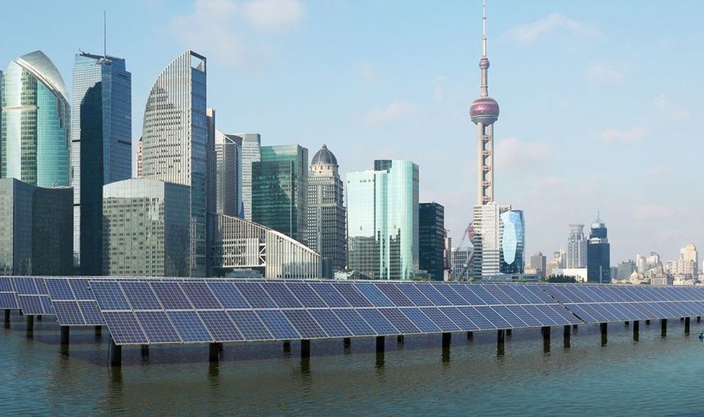 Solar panels with the Shanghai skyline in the distance. (123ArtistImages/iStock)