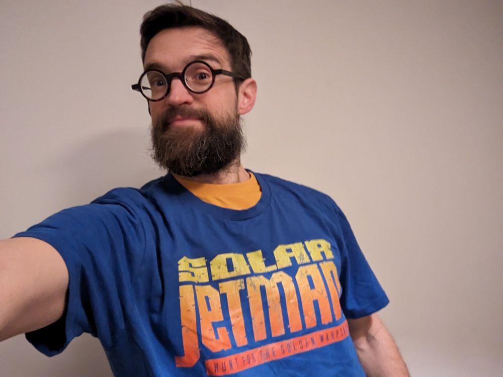 Me, a white bearded bespectacled male, wearing a blue t shirt with the Solar Jetman logo on it.