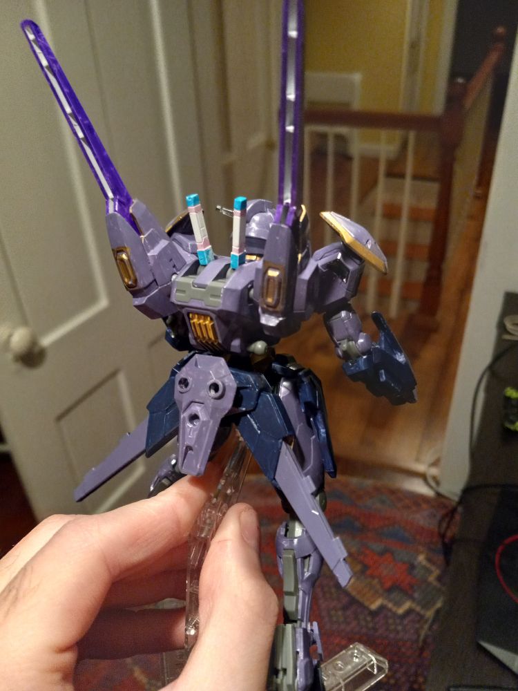 The same customised gunpla, seen from behind. The booster vents are painted gold. The stored beam saber handles are painted with the trans pride colors