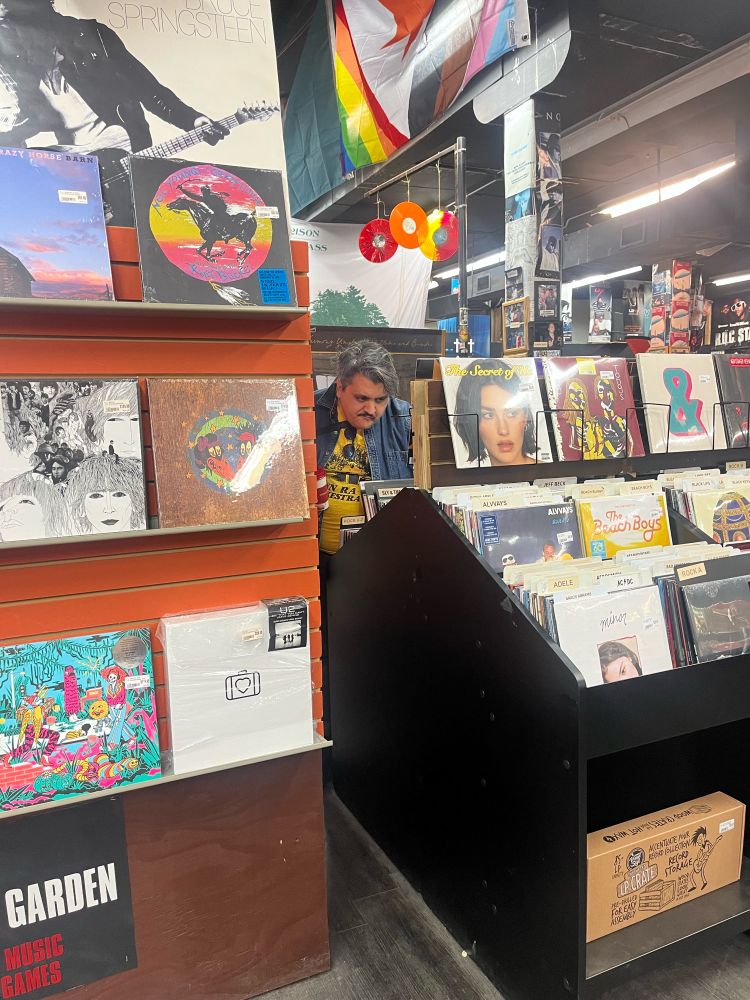 A disgruntled man is caught candidly between shelves as he searches for records at Sound Garden in Syracuse. 
