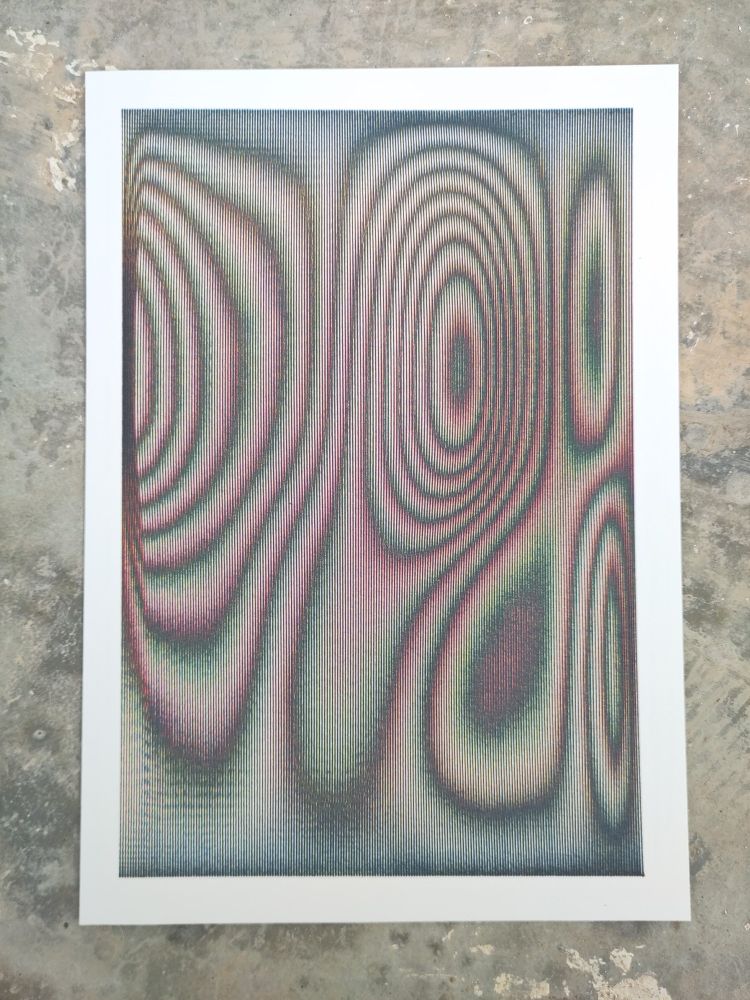 An abstract art piece featuring a complex pattern of lines and curves. The artwork is framed with a white border and is placed on a textured, concrete surface. The lines within the frame create a moiré effect, giving the illusion of depth and movement.