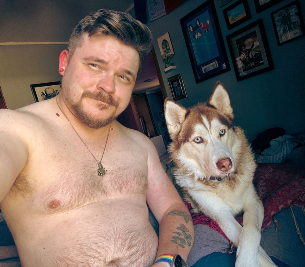 Sitting shirtless, with my husky son 