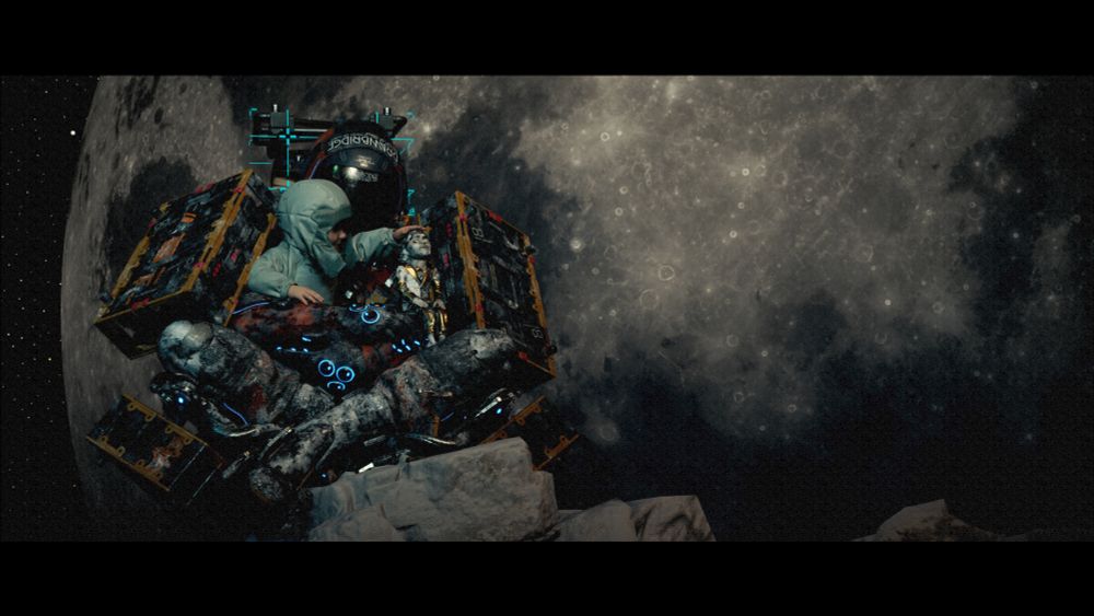 Sam dressed like a astronaut holding Lou as they pet doll man 