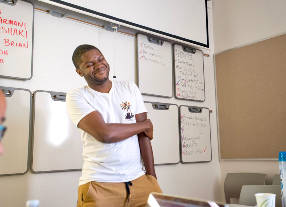 Aarron in white and khaki. Laughing cause i probably said some corny shit during a presentation. 