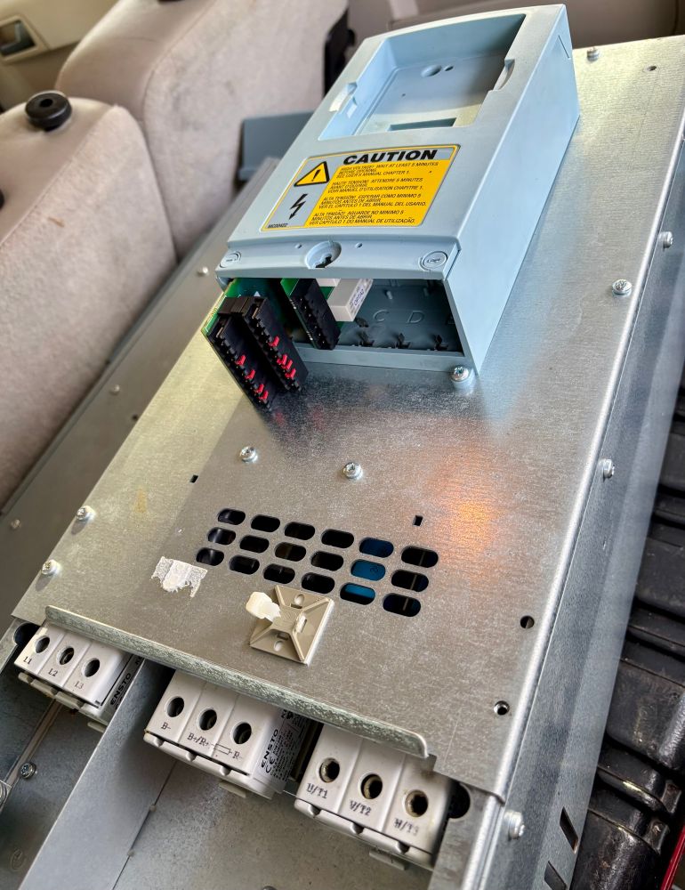 The uncovered face of a variable frequency motor driver. Removed after failure and sitting on a toolbox in the back of a car.