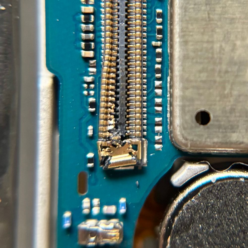Main motherboard connection on a Samsung A53 after the phone was dropped. It’s hard to see with the naked eye but looks fairly broken.