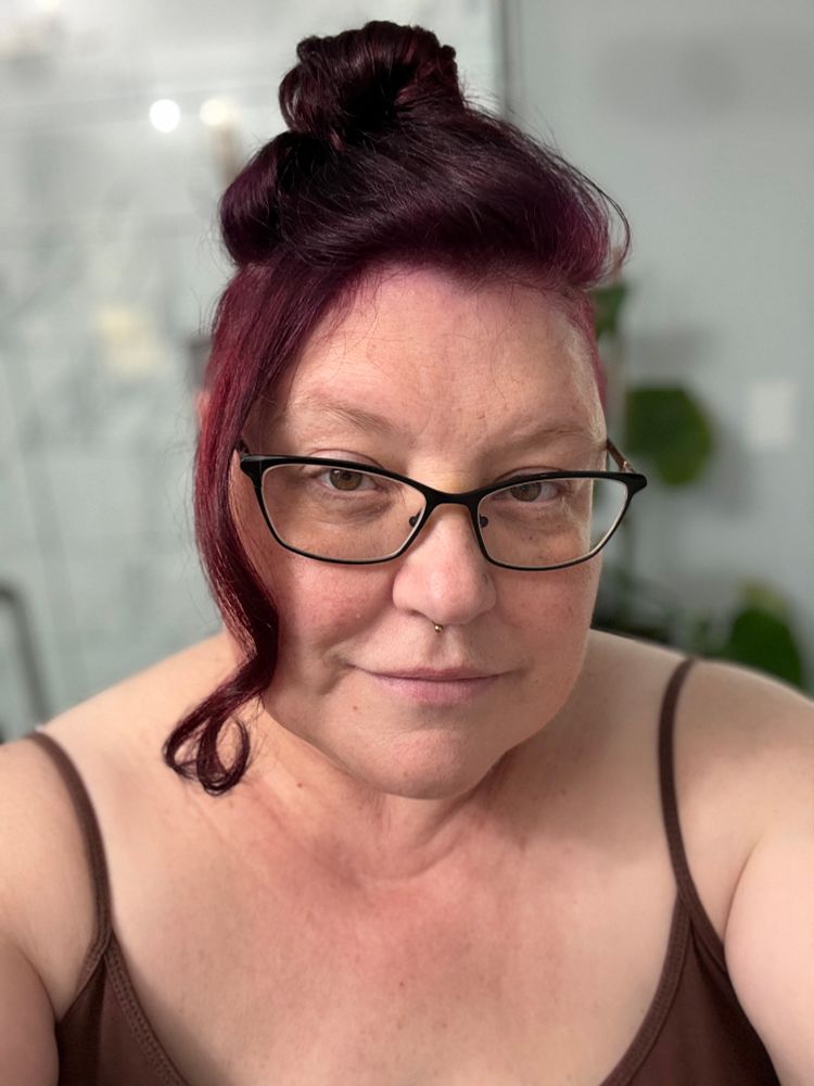 Purple hair person with their hair up 