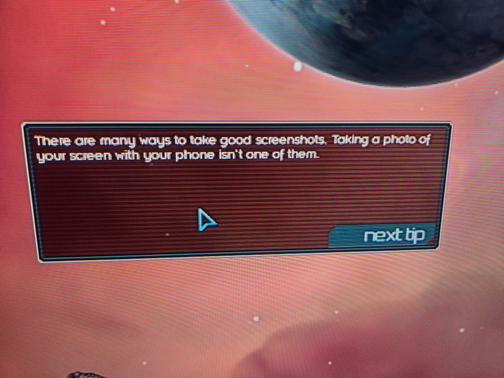 a photo of a menu tip reading "There are many ways to take good screenshots. Taking a photo of your screen with your phone isn't one of them."