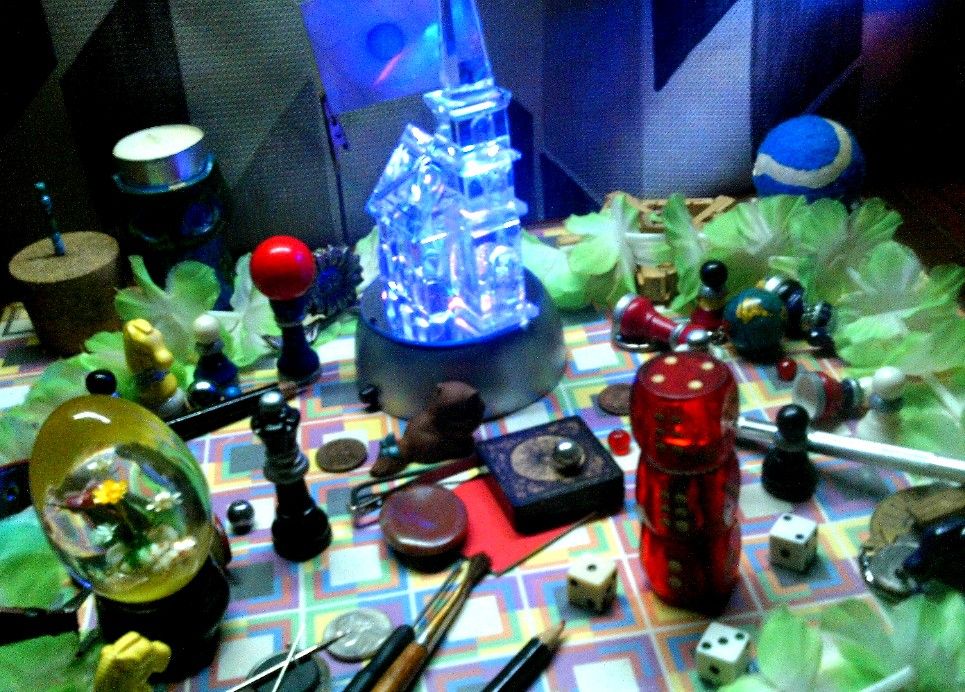Custom Glassware w/ Soul:

Just a bunch of stuff tossed onto a table, featuring a crystal church house sculpture glowing blue.