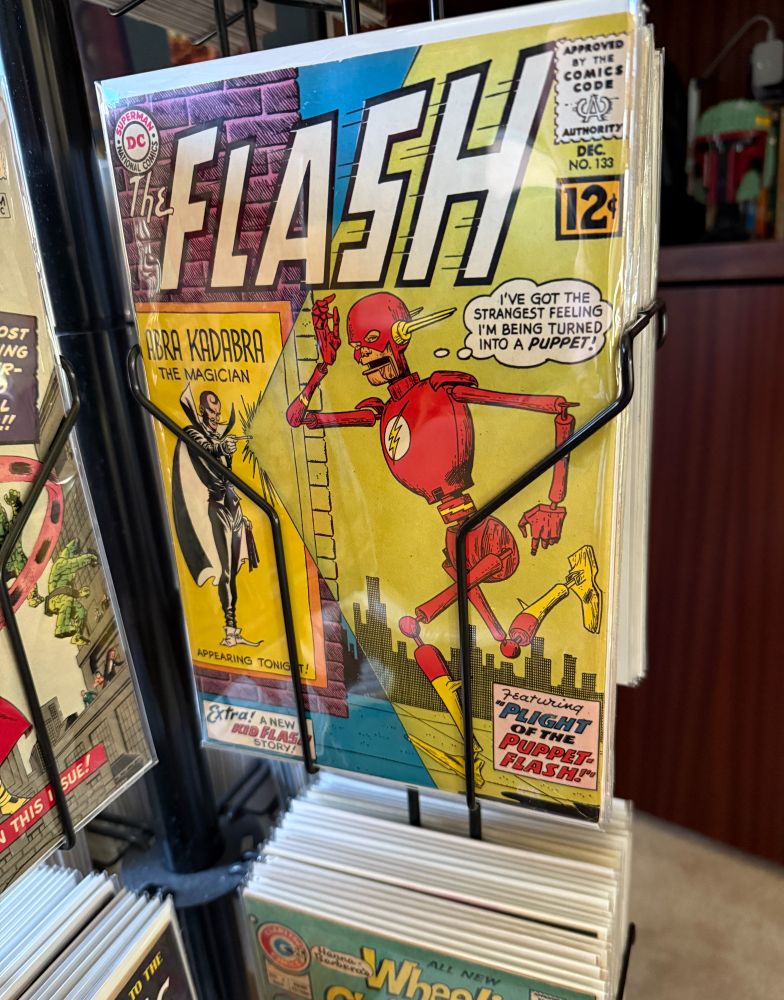Flash 133 comic book cover showing Flash turned into a puppet by Abra Kadabra