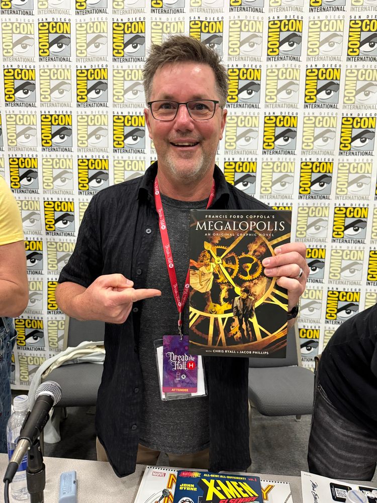 Chris Ryall—me—holding a copy of the coming Megalopolis graphic novel on the Abrams ComicArt panel at Comic-Con. 