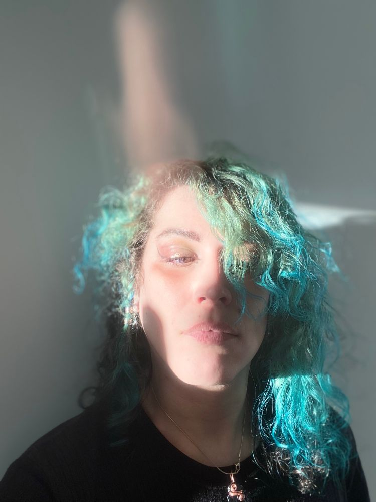 A selfie with a weird light effect, caused by broken phone screen