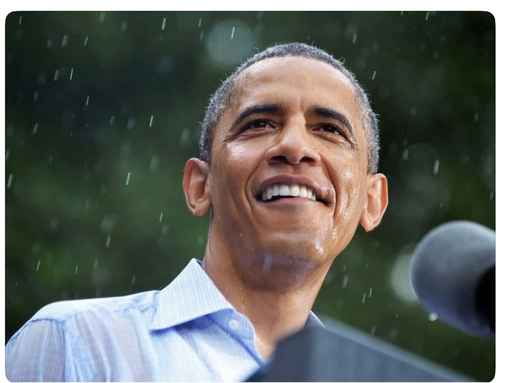 President Obama smiling in the rain