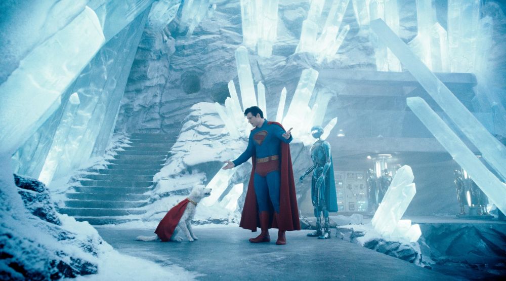 superman looking down at krypto sitting in his ice fortress. one of his helper robots standing nearby