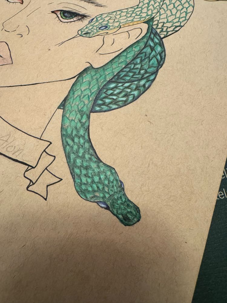 A partial drawing on tan paper featuring two green snakes with fine scales, one more detailed and the other in process of receiving details. 