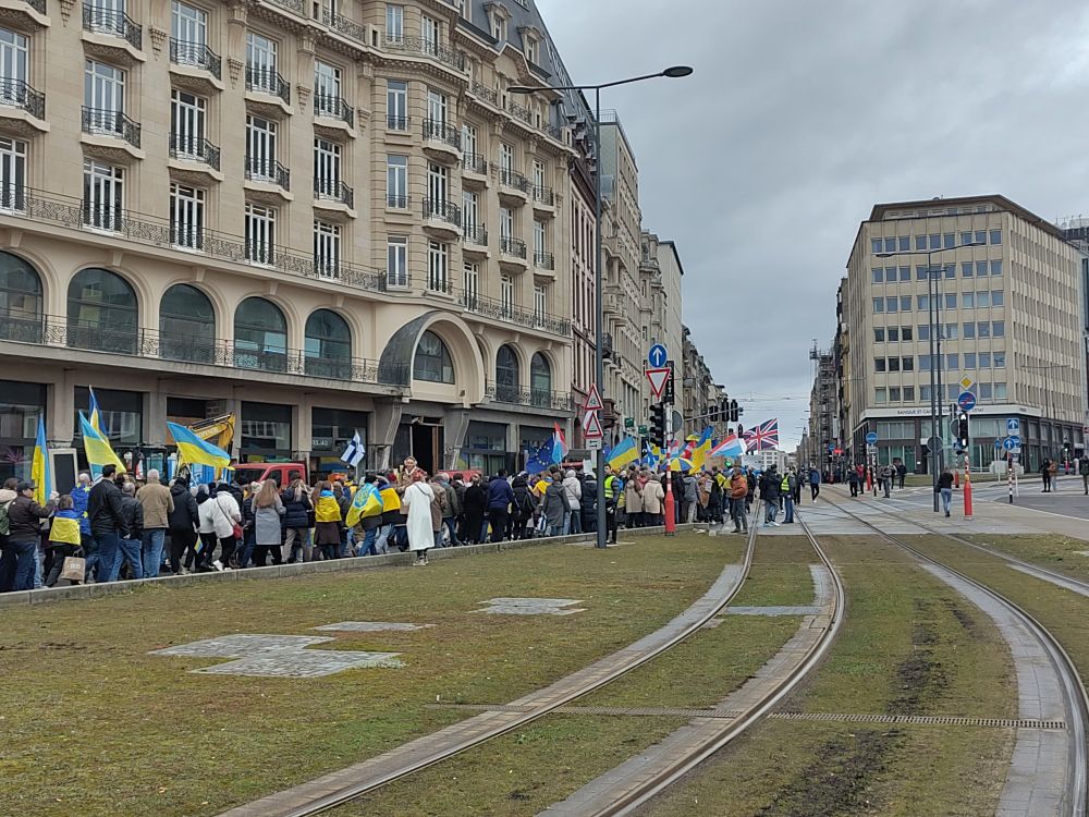 Crowd marching with Ukrainian and other flags, leaving from Gare Luxembourg going up Av. De la Liberté to show we stand with Ukraine. 