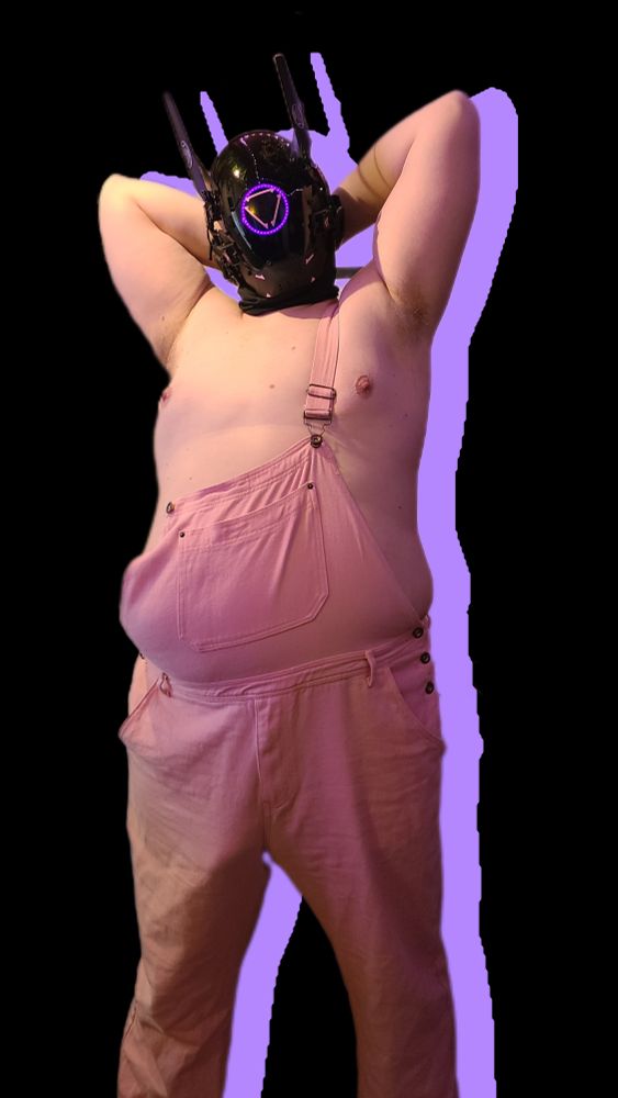 Robogut in pink overalls with its hands behind its head